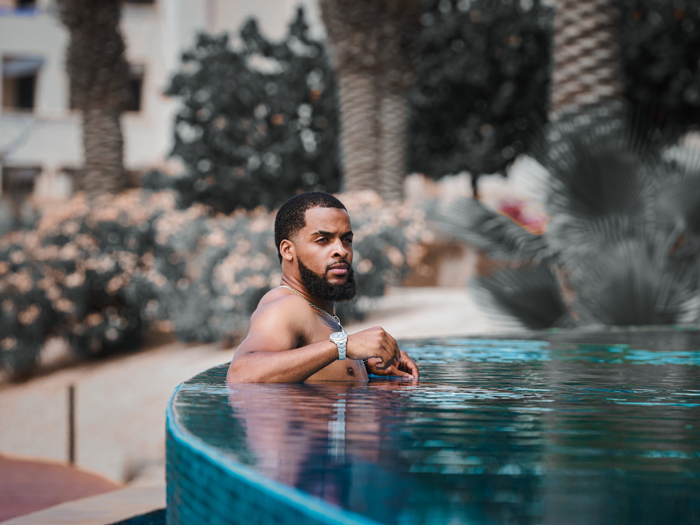 Zi Morris, American entrepreneur and SaaS tech founder, poolside at a luxury resort