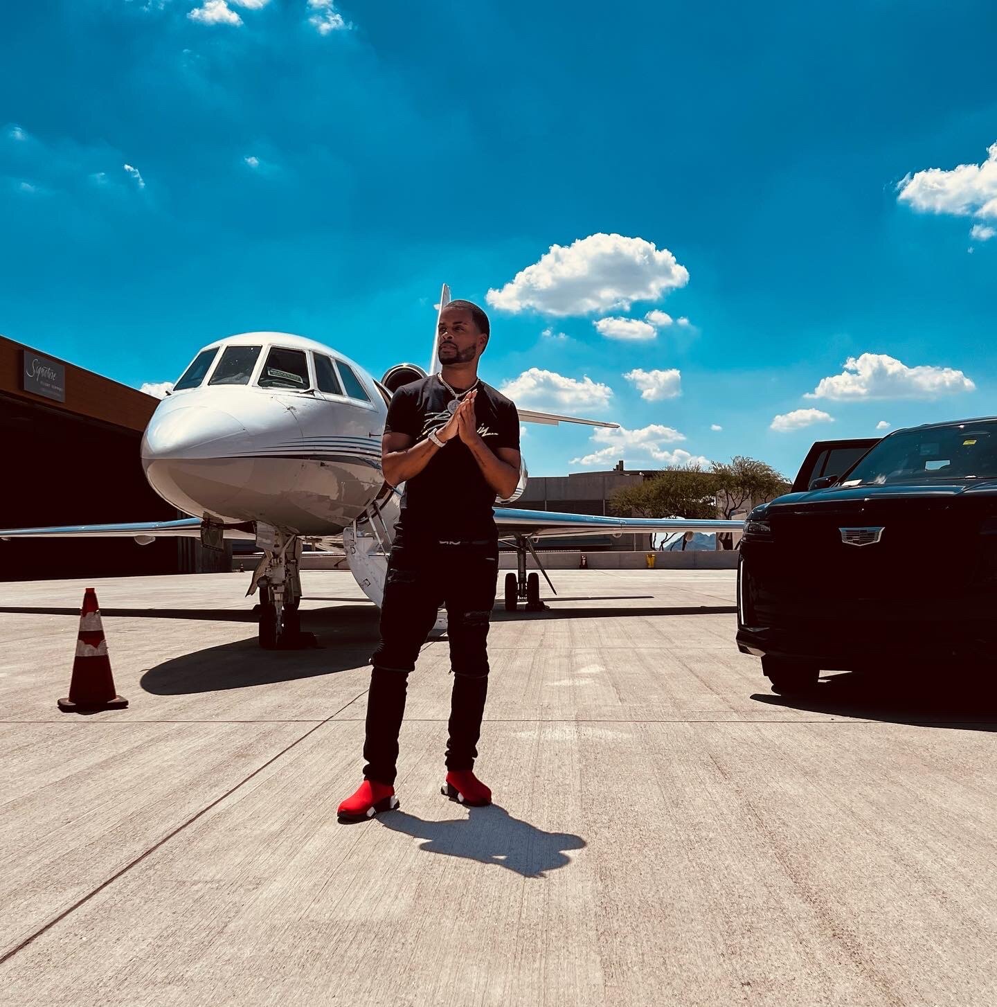 Zi Morris, American SaaS tech founder and investor, on the tarmac beside a private jet