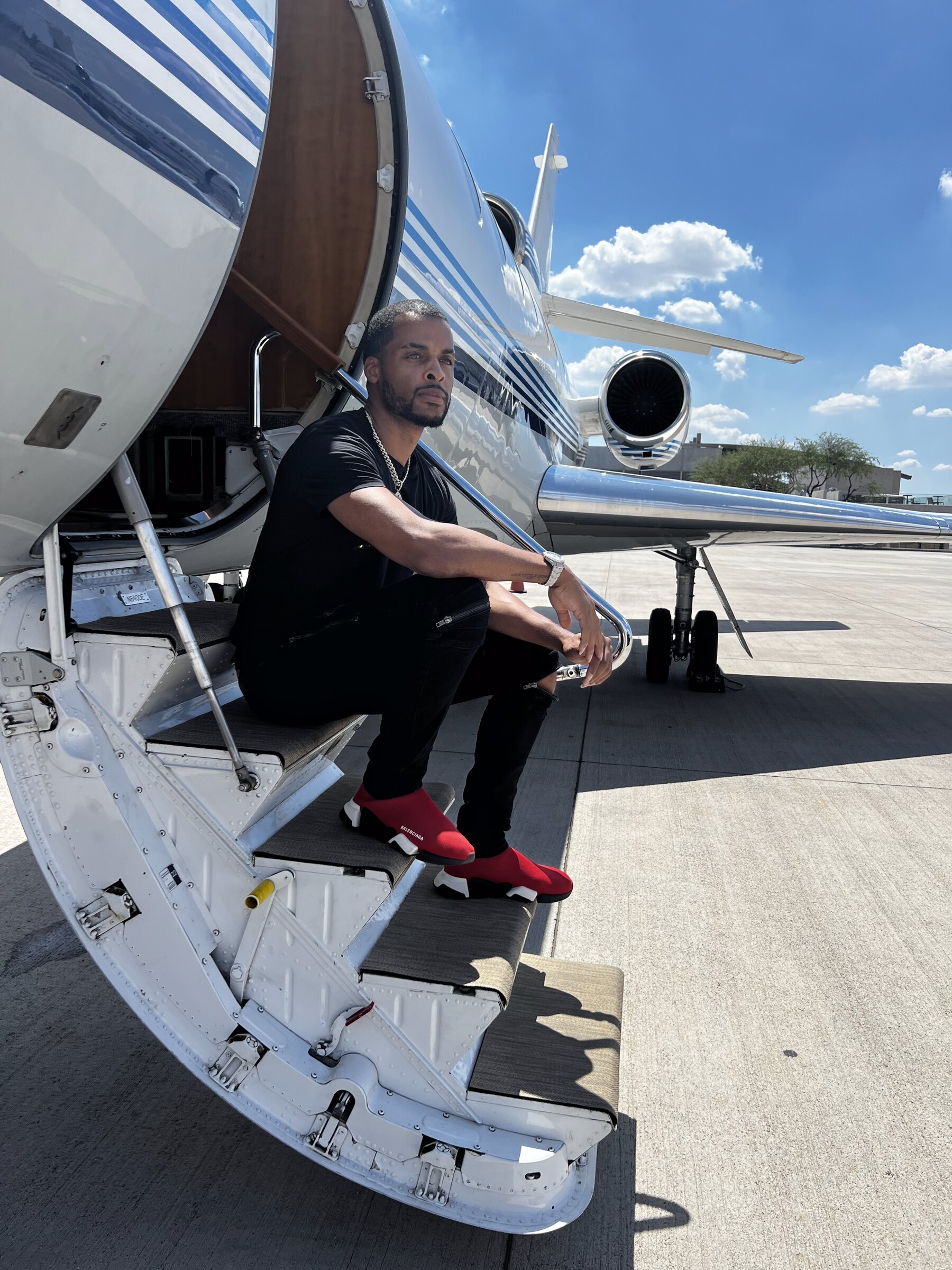 Zi Morris, American tech founder and investor, beside a private jet