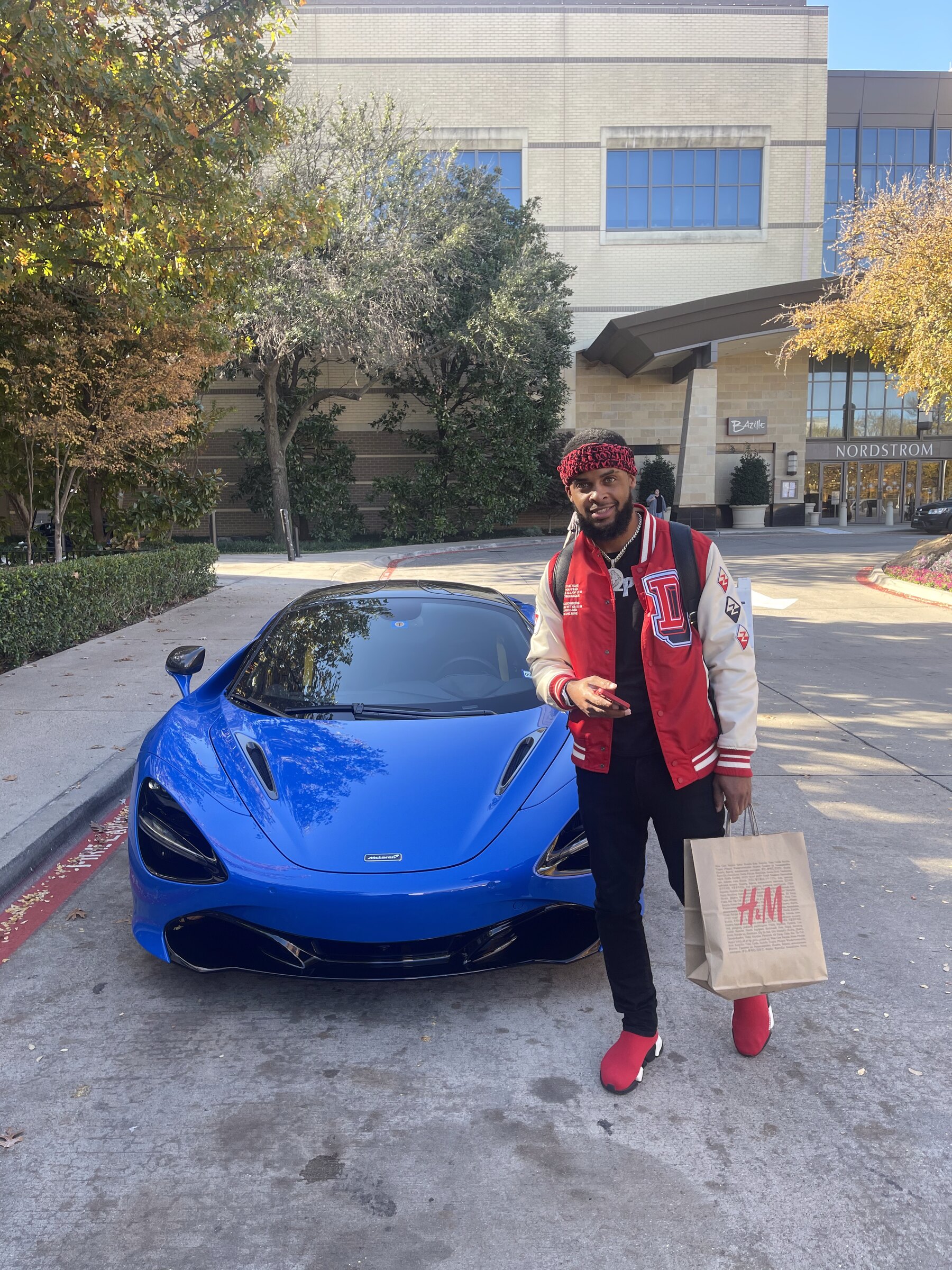 Zi Morris (Zi4reel), American entrepreneur and investor, with a McLaren supercar